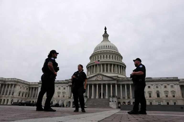 U.S. Capitol Police officers stand outside the Capitol dome as Senators vote, hours before a partial government shutdown is set to take effect on Capitol Hill in Washington, D.C., U.S., September 30, 2025. REUTERS/Jonathan Ernst